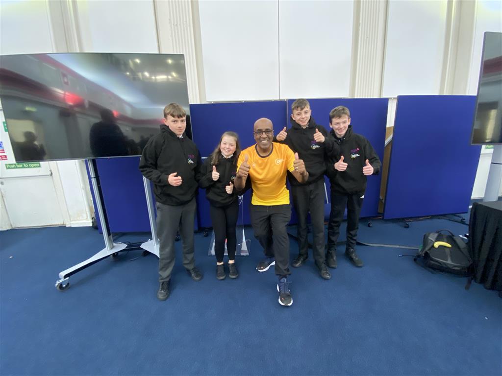 Four Central Academy students teach their peers about helping Children in Need